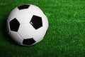 A soccer ball over a green grass field Royalty Free Stock Photo