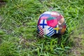 A soccer ball with a pattern in the form of flags of different countries on the grass Royalty Free Stock Photo