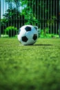 Soccer ball on penalty spot in cage football ground, street soccer in summer