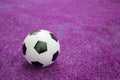 Soccer ball on pink grass Royalty Free Stock Photo