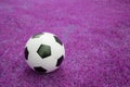 Soccer ball on pink grass