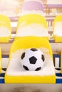 Soccer ball placed on snowy seats on stadium Royalty Free Stock Photo