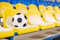 Soccer ball placed on snowy seats on stadium Royalty Free Stock Photo