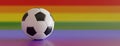 Soccer ball  on rainbow color background, close up. LGBT football sport event. 3d render Royalty Free Stock Photo