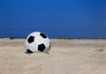 Soccer ball on sandy beach