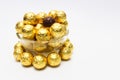 Soccer Ball-shaped chocolates in gold foil on a white background Royalty Free Stock Photo