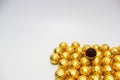 Soccer Ball-shaped chocolates in gold foil on a white background Royalty Free Stock Photo