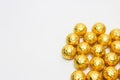 Soccer Ball-shaped chocolates in gold foil on a white background Royalty Free Stock Photo