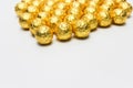 Soccer Ball-shaped chocolates in gold foil on a white background Royalty Free Stock Photo