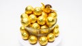 Soccer Ball-shaped chocolates in gold foil on a white background Royalty Free Stock Photo