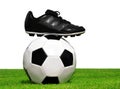 Soccer ball and shoes in grass Royalty Free Stock Photo