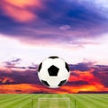 Soccer ball with soccer field against beautiful sunset Royalty Free Stock Photo