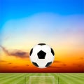 Soccer ball with soccer field against beautiful sunset Royalty Free Stock Photo