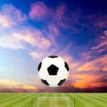 Soccer ball with soccer field against beautiful sunset Royalty Free Stock Photo