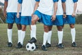 Soccer ball, sports group and feet of a team on a field to start fitness training or game outdoor. Football player, club Royalty Free Stock Photo