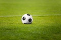 The Soccer Ball On Stadium Green Field. Football Pitch in the Background