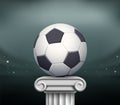 Soccer ball stands on a marble pillar pedestal Royalty Free Stock Photo