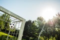 Soccer ball in top corner of the goal in summer