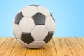 Soccer ball on the wooden table, 3D rendering