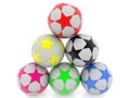 Soccer balls with colored stars stacked in a pyramid