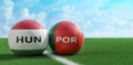 Soccer balls in Hungary and Portugal national colors on a soccer field. Royalty Free Stock Photo