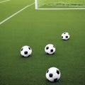 soccer balls are lying on a green football field Royalty Free Stock Photo