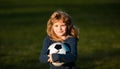 Soccer boy, child play football. Kid holding soccer ball, closeup kids portrait.