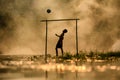 Soccer The boy silhouette playing football in the river