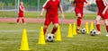 Soccer camp for kids. Boys practice dribbling in a field. Players develop good soccer dribbling skills Royalty Free Stock Photo