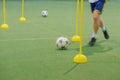 Soccer camp for kids. Children training soccer skills with balls and cones. Soccer slalom drills to improve football dribbling fas