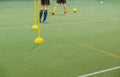 Soccer camp for kids. Children training soccer skills with balls and cones. Soccer slalom drills to improve football dribbling fas