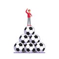 Soccer coach man standing on pile of big footballs