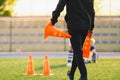 Soccer Coach Preparing Training Field. Trainer Holding Soccer Practice Cones