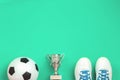 Soccer concept with football shoes, cup and ball