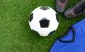Soccer concept : Football soccer ball, old soccer boots, blue
