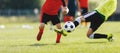 Soccer defensive player in action during a slide tackle. Two footballers in the competition game Royalty Free Stock Photo