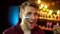 Soccer fan with argentinian flag painted on cheek happy team winning competition Royalty Free Stock Photo