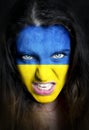 Soccer fan with Ukraine flag painted over face Royalty Free Stock Photo