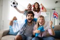 Soccer fans emotionally watching game in the living room. Royalty Free Stock Photo