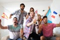 Soccer fans emotionally watching game in the living room. Royalty Free Stock Photo