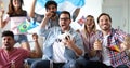 Soccer fans emotionally watching game in the living room. Royalty Free Stock Photo