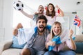 Soccer fans emotionally watching game in the living room. Royalty Free Stock Photo