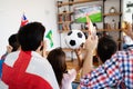 Soccer fans emotionally watching game in the living room. Royalty Free Stock Photo