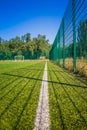 Soccer field with artificial green grass near the school. Amateur football field. Sunny summer day Royalty Free Stock Photo