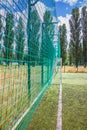 Soccer field with artificial green grass near the school. Amateur football field. Sunny summer day Royalty Free Stock Photo