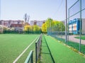 Soccer field with artificial green grass near the school. Amateur football field. Sunny summer day Royalty Free Stock Photo