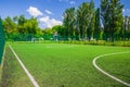 Soccer field with artificial green grass near the school. Amateur football field. Sunny summer day Royalty Free Stock Photo