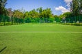 Soccer field with artificial green grass near the school. Amateur football field. Sunny summer day Royalty Free Stock Photo