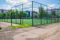 Soccer field with artificial green grass near the school. Amateur football field. Sunny summer day Royalty Free Stock Photo