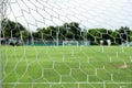 Soccer field from behind goal net Royalty Free Stock Photo